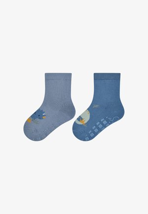 Chaussettes en coton pour enfants de différentes nuances de bleu. Une chaussette présente un animal de dessin animé, tandis que l'autre arbore un motif de lune et d'étoiles. Semelle antidérapante.