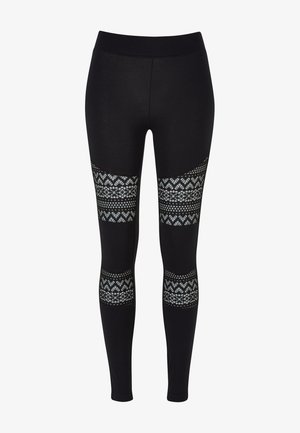 Mustad mustad leggings sileda tekstuuriga, millel on puusadel mustrilised lõiked lillemustriga helesinistes toonides.