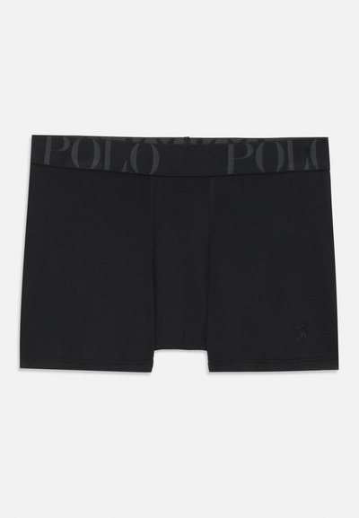 Juodi bokseriai, pagaminti iš minkštos medžiagos, su tamsiu juosmeniu, ant kurio kartojasi žodis „POLO“ ir mažas logotipas priekyje.