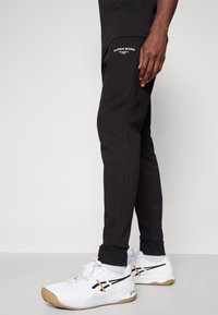 Björn Borg ESSENTIAL PANTS - Treniņtērpa apakšdaļas - black beauty
