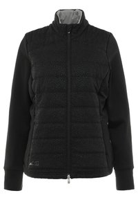 Veste matelassée noire avec fermeture éclair frontale, présentant un tissu supérieur lisse et un panneau inférieur matelassé, un motif texturé et un col montant.