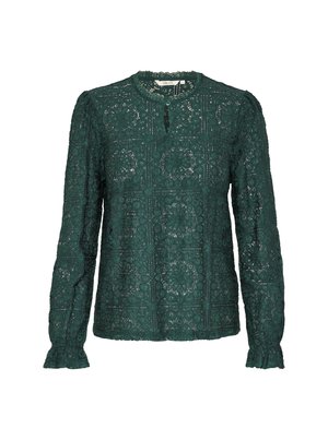 Green lace long-sleeve blouse with a round neckline, keyhole detail, and ruffled cuffs; features floral and geometric patterns.