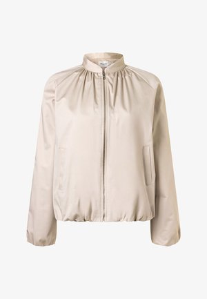 Světlounce béžová bunda na zip s našitým límcem, dlouhými rukávy, bočními kapsami a elastickým lemem.