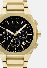 Kuldne roostevaba terasest kronograafkell musta dial'i, kolme aladiiali, kuupäevanäidiku ja harjatud pinna viimistlusega. Omab julgeid tunni näitajaid.