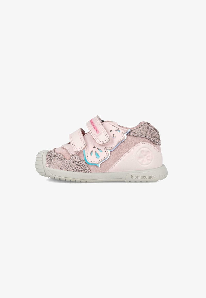 Chaussure pour tout-petit rose avec deux bandes velcro, ornée de suède et d'accents métalliques texturés, à bout arrondi et semelle en caoutchouc. Marque visible sur le côté.