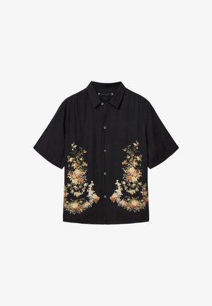Zwart button-up overhemd met korte mouwen, puntige kraag en symmetrische bloemenpatronen in beige, oranje en wit nabij de zoom.