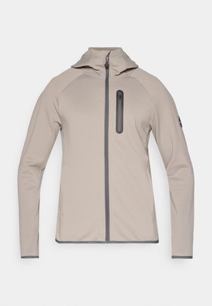 Lightweight, beige softshell jacket with a fitted hood, full front zipper, and a zippered chest pocket. Features raglan sleeves and contrasting trim.