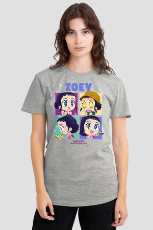 Young woman wearing a grey T-shirt with colorful cartoon faces of Zoey from K-Pop Demon Hunters in different expressions and activities.
