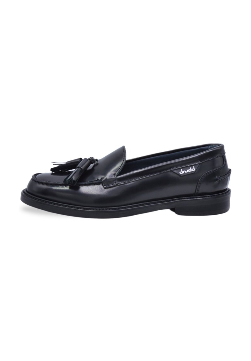 Black leather loafers featuring a rounded toe, a decorative tassel accent, and a low heel, with stitching detail along the sole.
