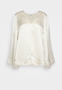Blouse en crêpe de soie avec manches longues, col en V et détails en franges le long des poignets et de l'ourlet.