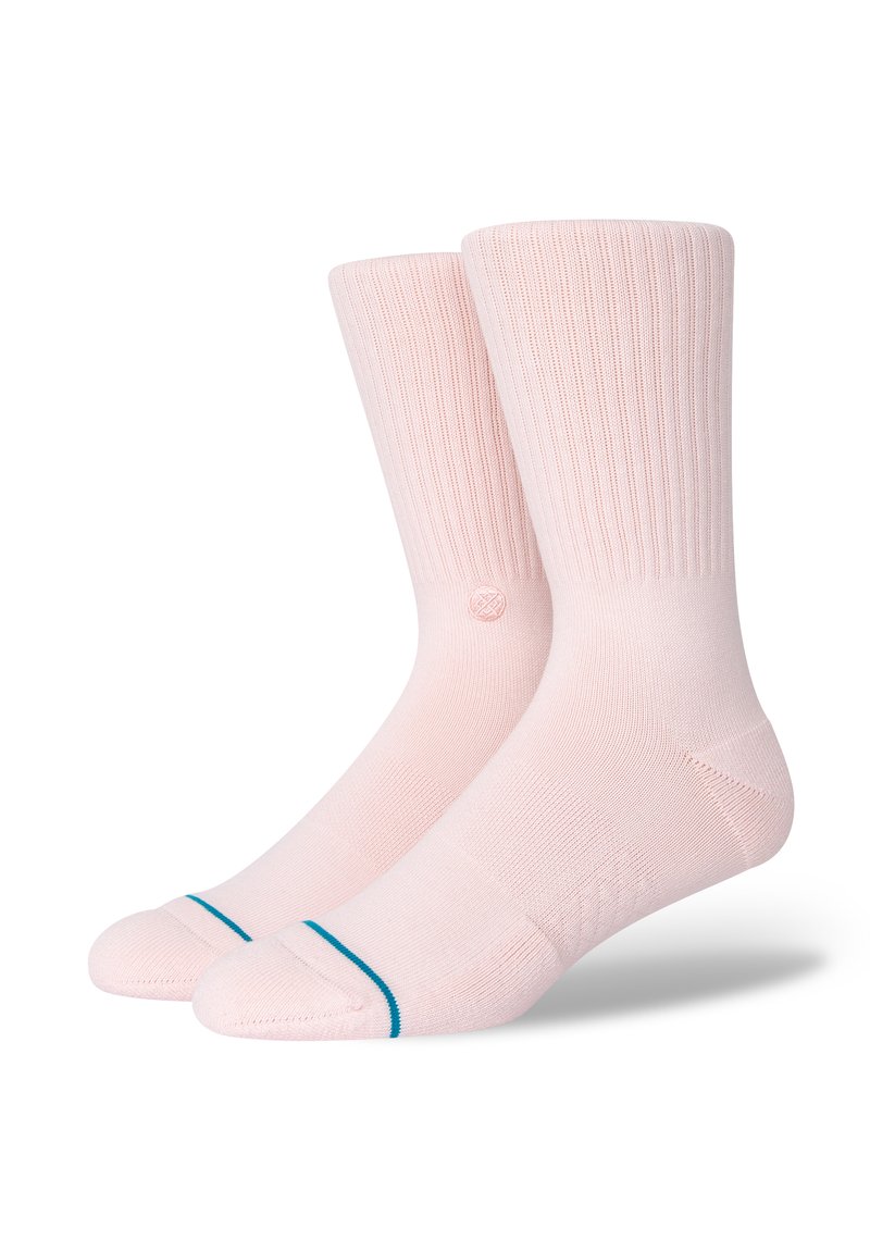 Pink crew socks featuring ribbed texture, contrasting teal accent stripes at the toe, and a small circular logo near the ankle.