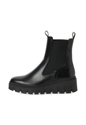 Botas negras hasta el tobillo con un exterior de cuero suave, paneles laterales elásticos y una suela gruesa con tacos. Presentan tiradores para facilitar el calzado.