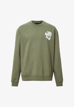 Vihreä puuvillaneule, jossa on pyöreä kaula-aukko, pitkät hihat ja valkoinen graafinen logo vasemmassa rintapielessä.