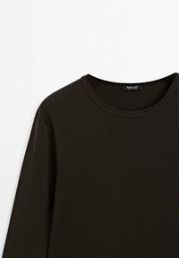 Dark brown long-sleeve t-shirt with a crew neck. Made from smooth, soft fabric with ribbed texture. Casual design, minimal detailing, and tag visible.