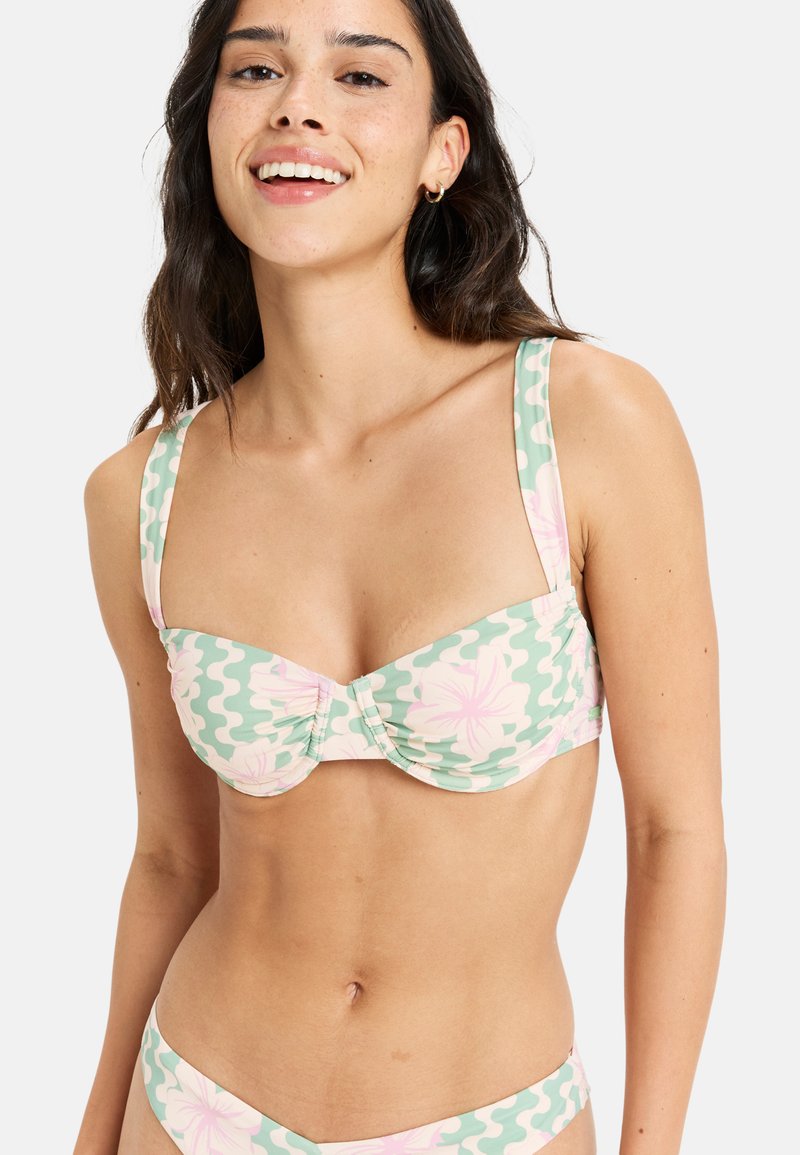 Green bikini with a floral pattern in pink and white. Features wide straps, a gathered center, and a soft fabric texture.