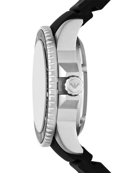 Silver stainless steel watch with a black rubber strap. Features a textured bezel and a prominent crown with a logo accent. Smooth surface.