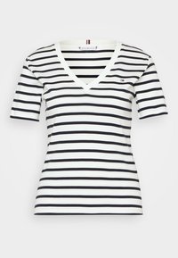 T-shirt a maniche corte con scollo a V, con righe orizzontali bianche e nere, dotato di un piccolo logo sul lato sinistro. Realizzato in morbido cotone.