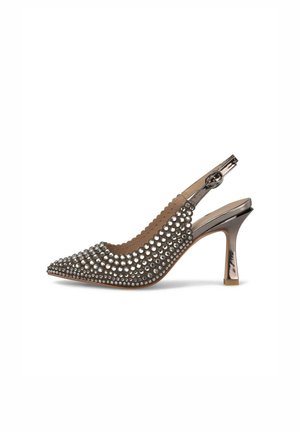 Scarpa con tacco slingback a punta beige con accenti metallizzati e adornata con borchie rotonde. Caratterizzata da un bordo ondulato e un tacco sottile.