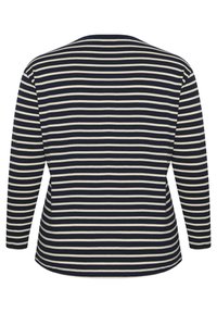 Long-sleeve top featuring navy and cream horizontal stripes, a round neckline, and a relaxed fit with a curved hemline.