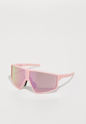 Pink oversized sunglasses with a matte finish, gradient lenses in pink and purple, and textured temples, featuring a geometric shape.