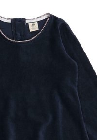 Navyblaue Cordkleid mit rundem Ausschnitt, ausgestattet mit einem kontrastierenden weißen und roten Besatz, einer Knopfverschluss hinten und langen Ärmeln.