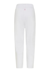 Hvide bukser i letvægtsstof med elastisk taljebånd. Bukserne har lige ben, sømløst design og et mærke på bagsiden.