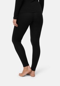 Schwarze Leggings aus weichem Stoff, mit einer körpernahem Design, glatter Textur und elastischem Bund, knöchellang, ohne Muster.