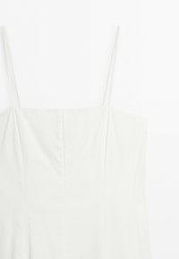 White sleeveless dress with thin spaghetti straps and a straight neckline, shown from the top front view.