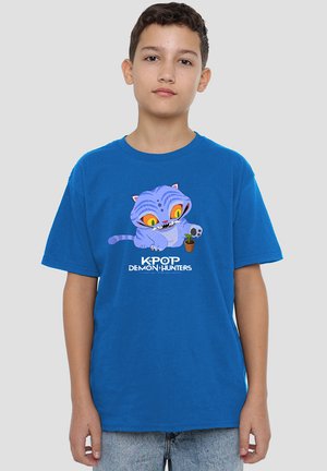 Blue cotton t-shirt featuring a cartoon cat with large yellow eyes, holding a green plant; text "KPOP DEMON HUNTERS" below the graphic.