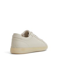 Sneakers in pelle beige con una texture liscia, design a punta rotonda e suola in gomma sottile e chiara. I lacci sono ben in evidenza.