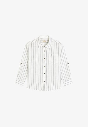 Valkoinen pitkähihaisia napitettavaa paitaa, jossa on sinisiä pystysuoria raitoja. Paita sisältää rintataskun, pyöreän kauluksen ja napitetut hihansuut. Valmistettu kevyestä kankaasta.