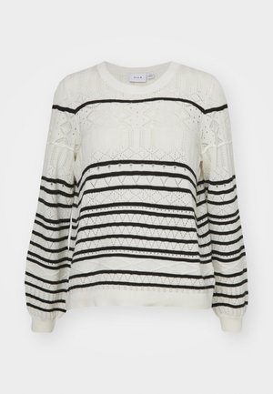 Pull en tricot avec une base crème et des rayures horizontales noires, des motifs géométriques, des poignets côtelés et un col rond.