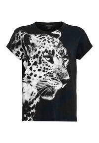 T-shirt en coton noir avec un graphique de léopard blanc. Manches courtes, design col rond et coupe décontractée. Texture lisse.