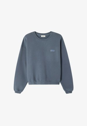 Sudadera de algodón azul con escote redondo, puños y dobladillo acanalados. Presenta un pequeño logo "American Vintage" en un tono más claro en la parte frontal.
