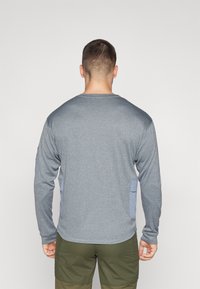 Gray long-sleeve shirt with textured fabric, featuring light blue accent panels on the sides, round neckline, and regular fit.