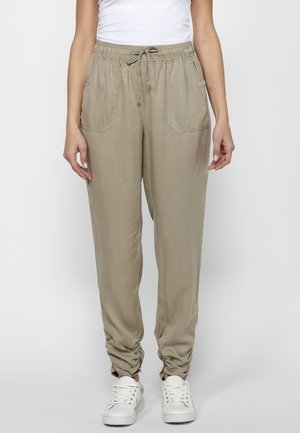 Lichtbeige utility broek met een elastische tailleband, verstelbaar trekkoord en twee voorkruiden. Gemaakt van een zachte, gestructureerde stof.
