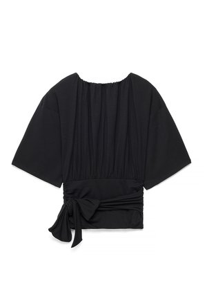 Black short-sleeve blouse with wide sleeves, gathered neckline, ruched waist, and a tied bow detail on the left side.