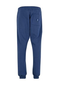 Marineblauwe joggingbroek van zachte stof, met een elastische tailleband, enkelboorden en een achterzak met een labeldetail.