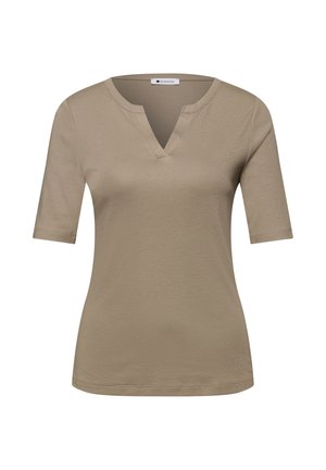 Haut beige à manches courtes pour femmes avec un décolleté en V échancré et une silhouette ajustée sur fond blanc.