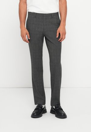 Gray checkered dress pants with a tailored fit, featuring a flat front, belt loops, and side pockets. Worn with black loafers.