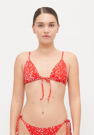 Red bikini with a floral pattern, featuring a triangular top with adjustable ties and matching side-tie bottoms. Smooth, stretchy material.
