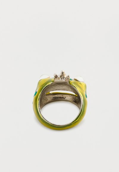 Frog-shaped ring featuring a shiny silver interior, green enamel exterior, two clear stones for eyes, and a silver crown detail at the top.