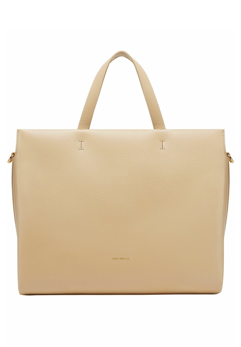 Beige læder tote taske med to håndtag, flad design, diskrete syninger og et guldlogo i bunden af midten.