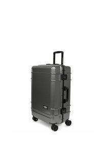 Valigia rigida di colore grigio scuro, con manico telescopico, quattro ruote girevoli, maniglia laterale e lucchetto integrato. Superficie texturizzata.