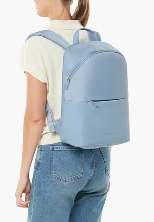Light blue vegan leather backpack with two shoulder straps, a front zip pocket, and a smooth, minimalist design.