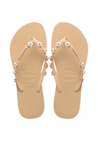 Șlapi de culoare piersică cu embellishments florale, talpă din cauciuc texturat și bretele contrastante cu mărgele argintii și accente florale.