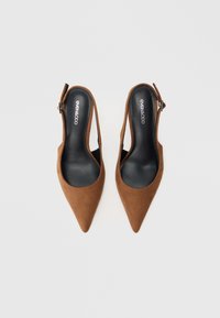 Pantofi slingback din piele întoarsă maro, cu vârf ascuțit, cu o curea subțire reglabilă și o căptușeală interioară netedă de culoare neagră.