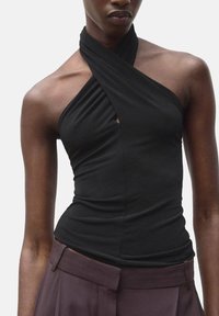 Black halter top features a twisted design with a keyhole detail at the chest. Made of smooth, stretchy fabric, fitted silhouette.