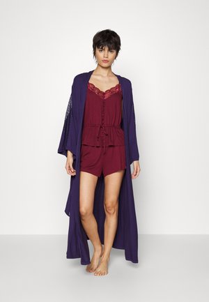 Burgundy shorts and matching camisole with lace accents, layered under a long, flowy purple kimono. Soft fabric with a relaxed fit.