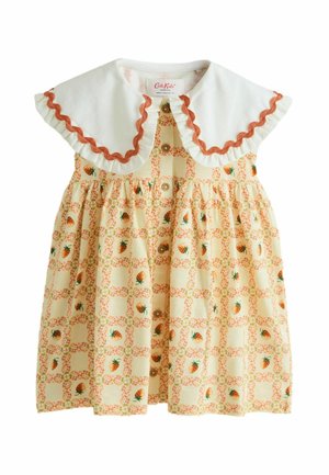 Cream-colored toddler dress with large white ruffled collar, orange zigzag trim, button front, and small strawberry and floral grid pattern.